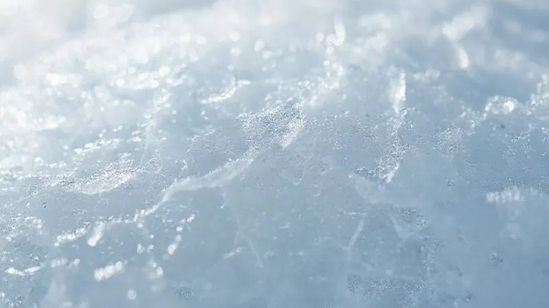 A close-up, photorealistic shot of highly fractured, crystalline ice with visible air pockets and a thin layer of rime, depicting the brittle nature of mixed ice. Cinematic lighting highlights the delicate structure, 8K, sharp focus, depth of field.